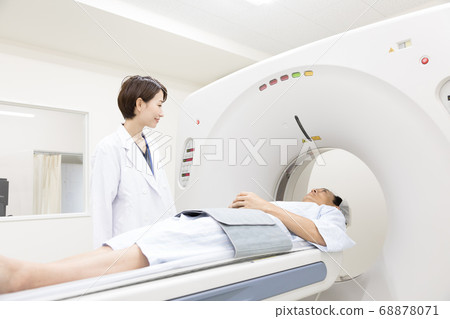 Middle-aged man undergoing CT examination Middle-aged man undergoing CT examination 68878071