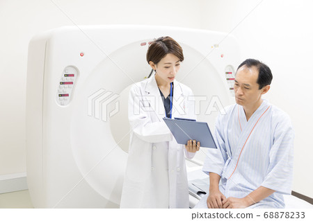 Middle-aged man undergoing CT examination Middle-aged man undergoing CT examination 68878233