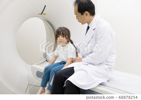 Girl undergoing CT examination 68878254