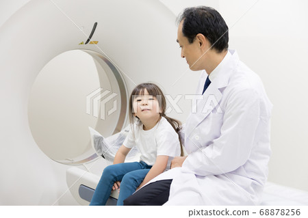 Girl undergoing CT examination 68878256