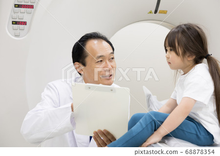Girl undergoing CT examination 68878354