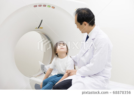 Girl undergoing CT examination 68878356