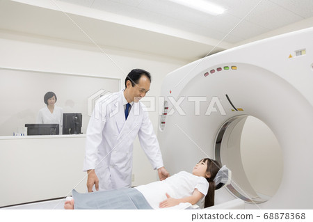 Girl undergoing CT examination 68878368