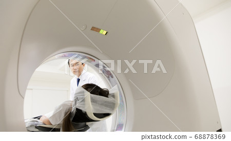 Girl undergoing CT examination 68878369