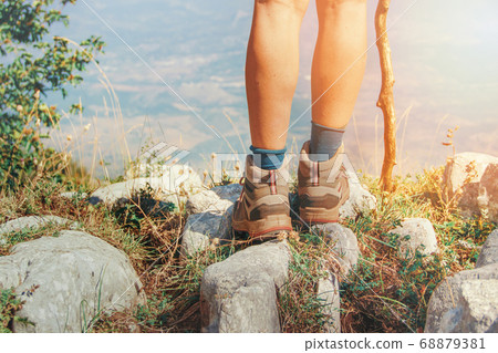 Close up of women legs wearing hiking boots in Close up of women legs wearing hiking boots in 68879381