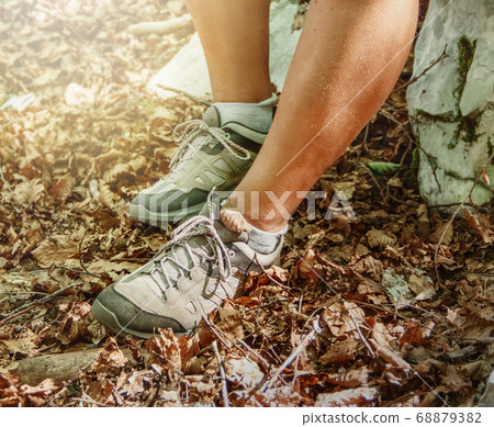 Close up of women legs wearing hiking boots Close up of women legs wearing hiking boots 68879382