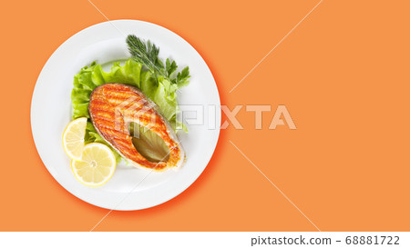 Grilled salmon with lemon and salad Grilled salmon with lemon and salad 68881722