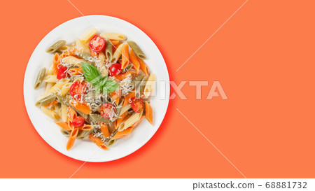 Colorful penne pasta with tomatoes and basil Colorful penne pasta with tomatoes and basil 68881732