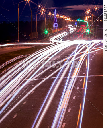 Traces of headlights from cars moving at night on 68881865