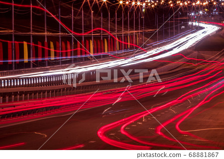 Traces of headlights from cars moving at night on 68881867