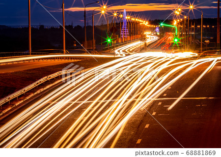 Traces of headlights from cars moving at night on 68881869