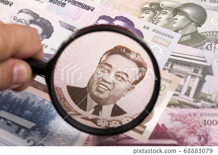 North Koreans money in a magnifying glass a business background 68883079