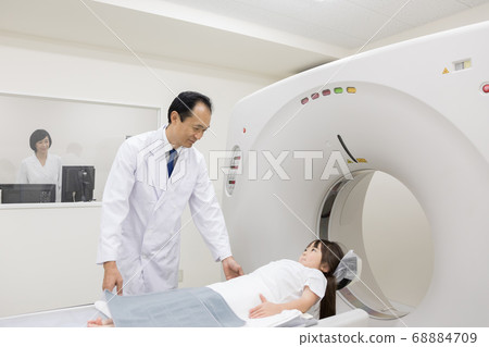 Girl undergoing CT examination 68884709