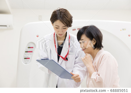 Middle-aged woman undergoing CT examination 68885051