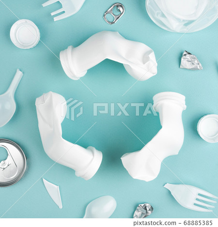 Three crashed plastic bottles on blue background in recycling sign. Recycling plastic concept. Three crashed plastic bottles on blue background in recycling sign. Recycling plastic concept. 68885385