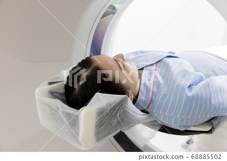 Young woman undergoing CT examination 68885502