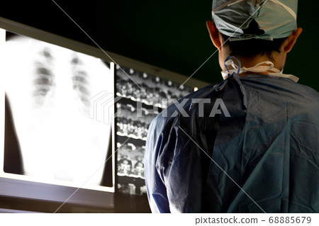 Surgeon checking the X-ray Surgeon checking the X-ray 68885679