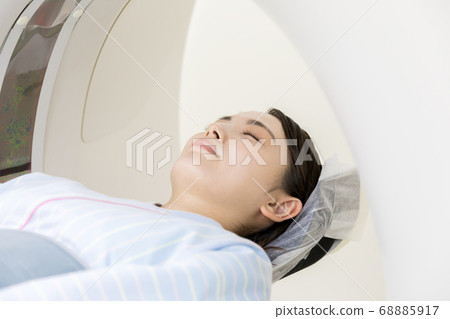 Young woman undergoing CT examination 68885917