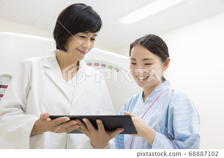 Young woman undergoing CT examination 68887102