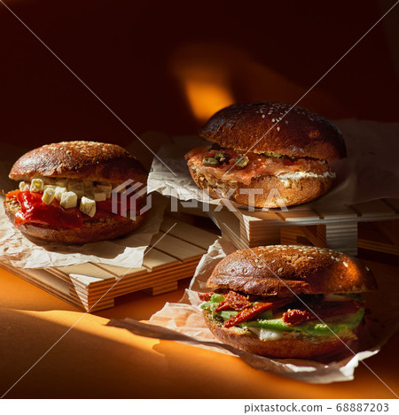 Three Salmon Sandwich with Greek Goat Cheese Pesto and Grilled Bell Peppers. Delicious snacks with wine, snacks or breakfast. Three Salmon Sandwich with Greek Goat Cheese Pesto and Grilled Bell Peppers. Delicious snacks with wine, snacks or breakfast. 68887203
