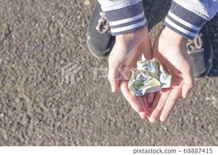 A child holds coins and euro notes in his hands. Pocket money image. Poor low-income family, the concept of poverty, begging 68887415
