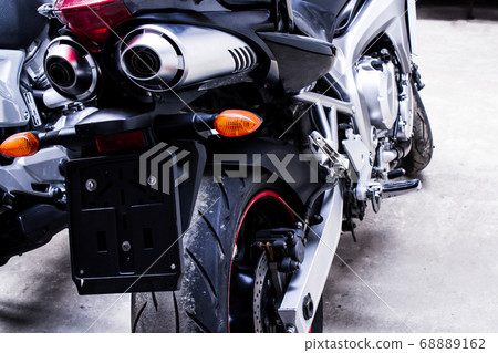 Back exhaust pipe of sportbike close-up in garage 68889162