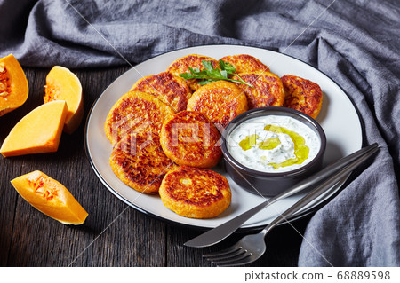 Low-calorie butternut squash pancakes on a plate Low-calorie butternut squash pancakes on a plate 68889598