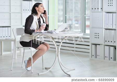 Portrait of beautiful young woman with smartphone working Portrait of beautiful young woman with smartphone working 68890009