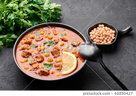 Moroccan Harira Soup in black bowl at dark slate table top 68890427