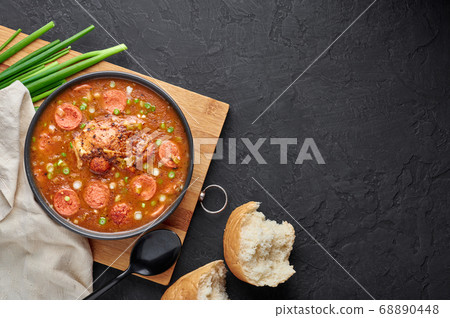 Chicken and Sausage Gumbo soup in black bowl  68890448