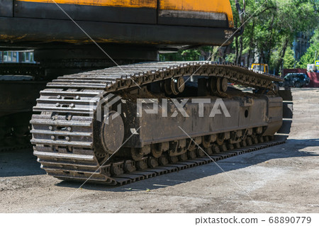 Close-up of a heavy duty tractor track or military vehicle while parked Close-up of a heavy duty tractor track or military vehicle while parked 68890779