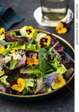 Spring salad with arugula, herbs and flowers. Spring salad with arugula, herbs and flowers. 68891105