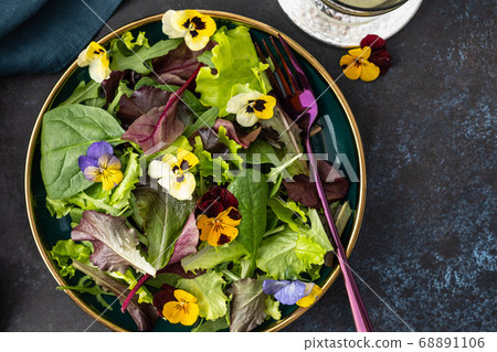 Spring salad with arugula, herbs and flowers. Spring salad with arugula, herbs and flowers. 68891106