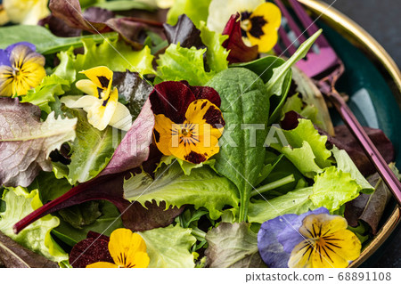 Spring salad with arugula, herbs and flowers. Spring salad with arugula, herbs and flowers. 68891108