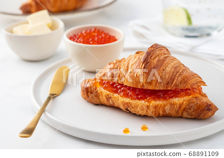 Red caviar and croissant for breakfast, selective focus. Luxury breakfast. Red caviar and croissant for breakfast, selective focus. Luxury breakfast. 68891109