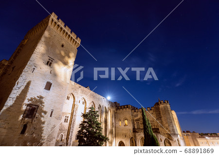 Beautiful night view of the Palace of the Popes with the rising moon in Avignon city 68891869