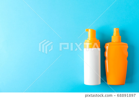 Composition with sunscreen sprays on color Composition with sunscreen sprays on color 68891897