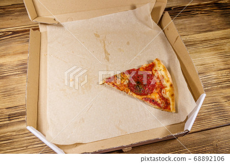 Last slice of pizza in cardboard box 68892106