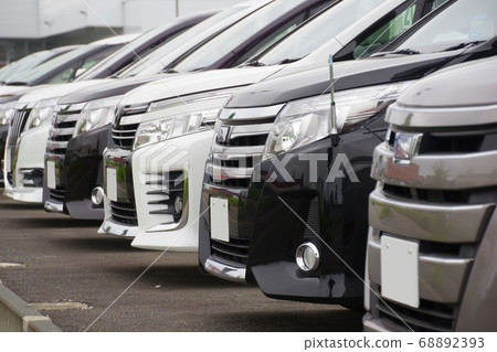Minivans lined up at dealerships 68892393