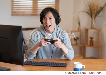 Young men playing online games 68892853