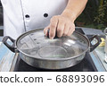 Chef prepared water to pot for make mashed 68893096