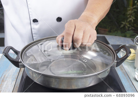 Chef prepared water to pot for make mashed Chef prepared water to pot for make mashed 68893096