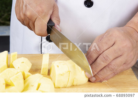 Chef cutting potato to make mashed Potatoes Chef cutting potato to make mashed Potatoes 68893097