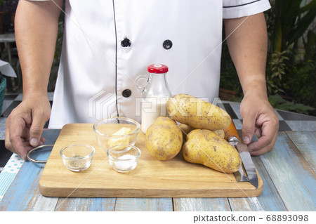 Chef and Ingredients to make mashed Potatoes 68893098