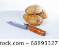 Paring knife wooden handle and potato 68893327