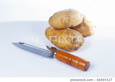 Paring knife wooden handle and potato Paring knife wooden handle and potato 68893327