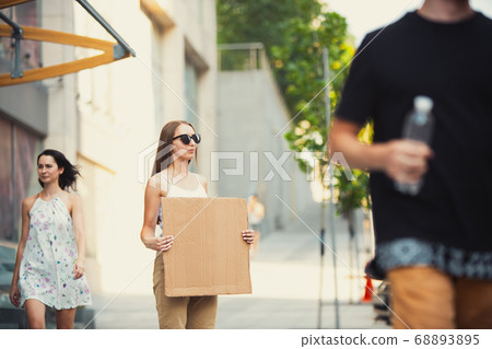 Dude with sign - woman stands protesting things that annoy her 68893895