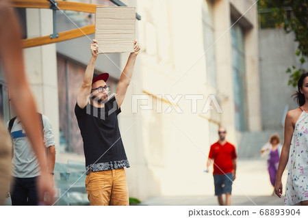 Dude with sign - man stands protesting things that annoy him 68893904