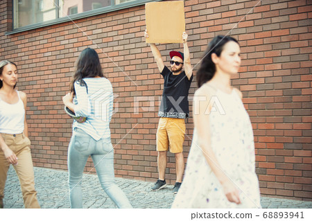 Dude with sign - man stands protesting things that annoy him 68893941