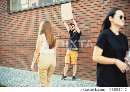 Dude with sign - man stands protesting things that annoy him 68893942